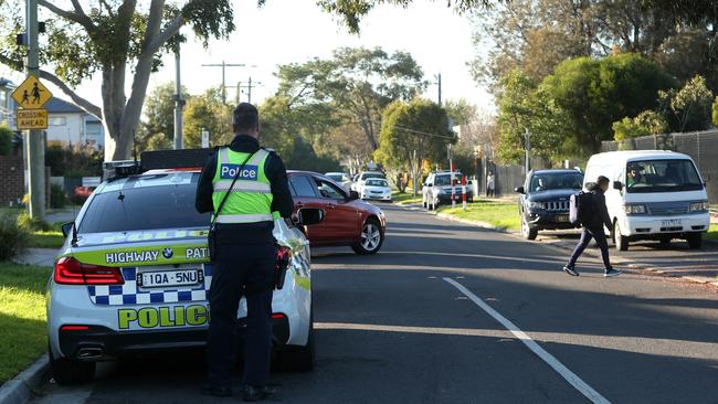 Acting Sergeant Stephen Little monitors traffic outside Glenroy West Primary School. Picture: Hamish Blair