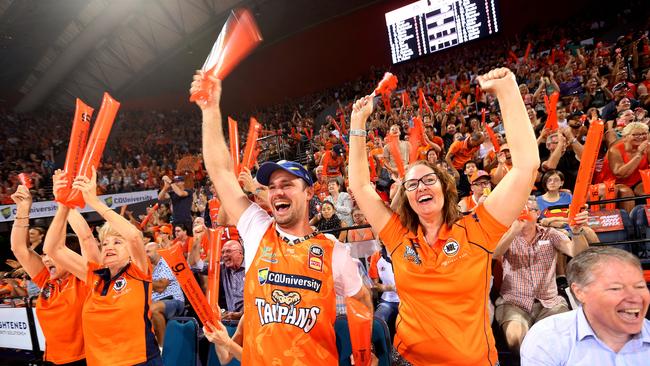 Taipans supporters Darren Tonkin from Westcourt and Naomi McKinnon cheer on the Taipans on their way to winning a the second game in last year’s NBL Finals. PICTURE: STEWART McLEAN