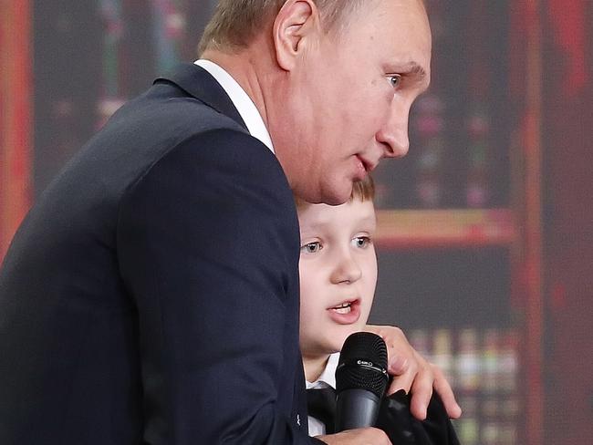 Child prodigy Miroslav Oskirko gets a history lesson from Vladimir Putin. Picture: Sergei Ilnitsky/Pool photo via AP