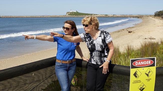 Willow Forsyth, left, Stockton resident & Director of Education at Stockton Surf Life Saving Club, talks with Barbara Whitcher, Secretary of the Stockton Community Action Group and chair of the Stockton Community Liason Group, near the barricade that prevents beach access at the surf club.