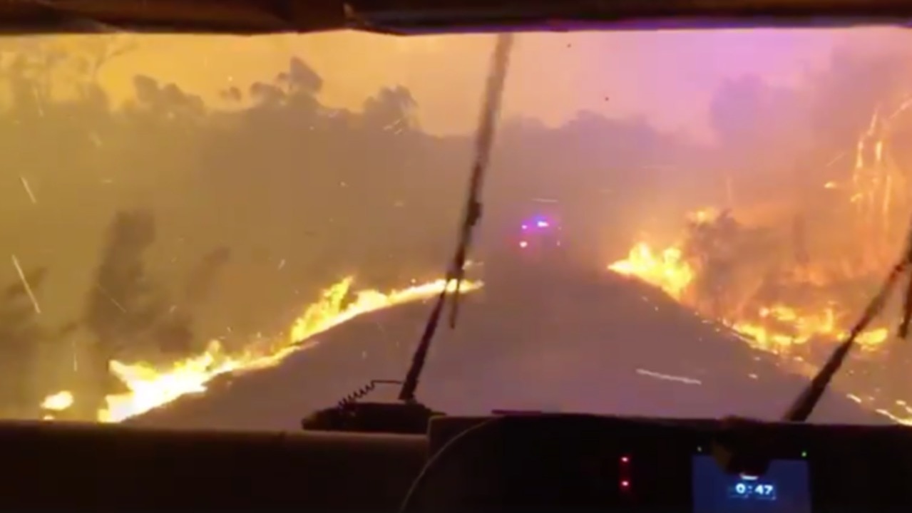 Fire fighters drive through smoke and flames to protect homes on Sydney’s outskirts