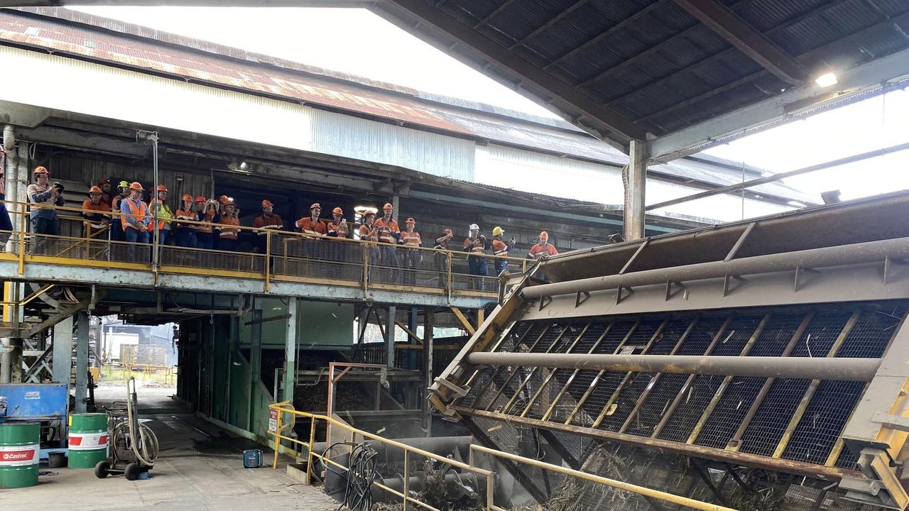 Far North Milling workers look on as the final bin of the 2023 season was crushed at the at Mossman Mill on November 23. Picture: Far North Milling