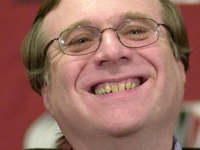 FILE - In this Feb. 10, 2004, file photo, Portland Trail Blazers owner Paul Allen smiles as he talks to the media at the Rose Garden arena during halftime of the Blazers game against the Utah Jazz in Portland, Ore. Allen, billionaire owner of the Portland Trail Blazers and the Seattle Seahawks and Microsoft co-founder, died Monday, Oct. 15, 2018 at age 65. Earlier this month Allen said the cancer he was treated for in 2009, non-Hodgkin's lymphoma, had returned. (AP Photo/Don Ryan, file)