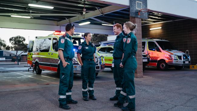 Paramedic Caitlin Little chats to colleagues outside their Alice Springs station. Picture: Australian Catholic University