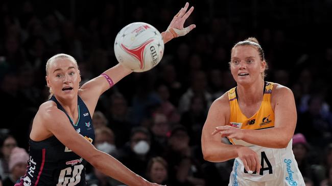 Steph Fretwell passes the ball as Jo Weston of the Melbourne Vixens attempts to block. Picture: Asanka Ratnayake/Getty Images.