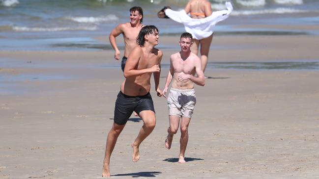 Schoolies enjoy a bit of sun at Clarkes Beach in Byron Bay on Saturday. Photograph: Jason O'Brien
