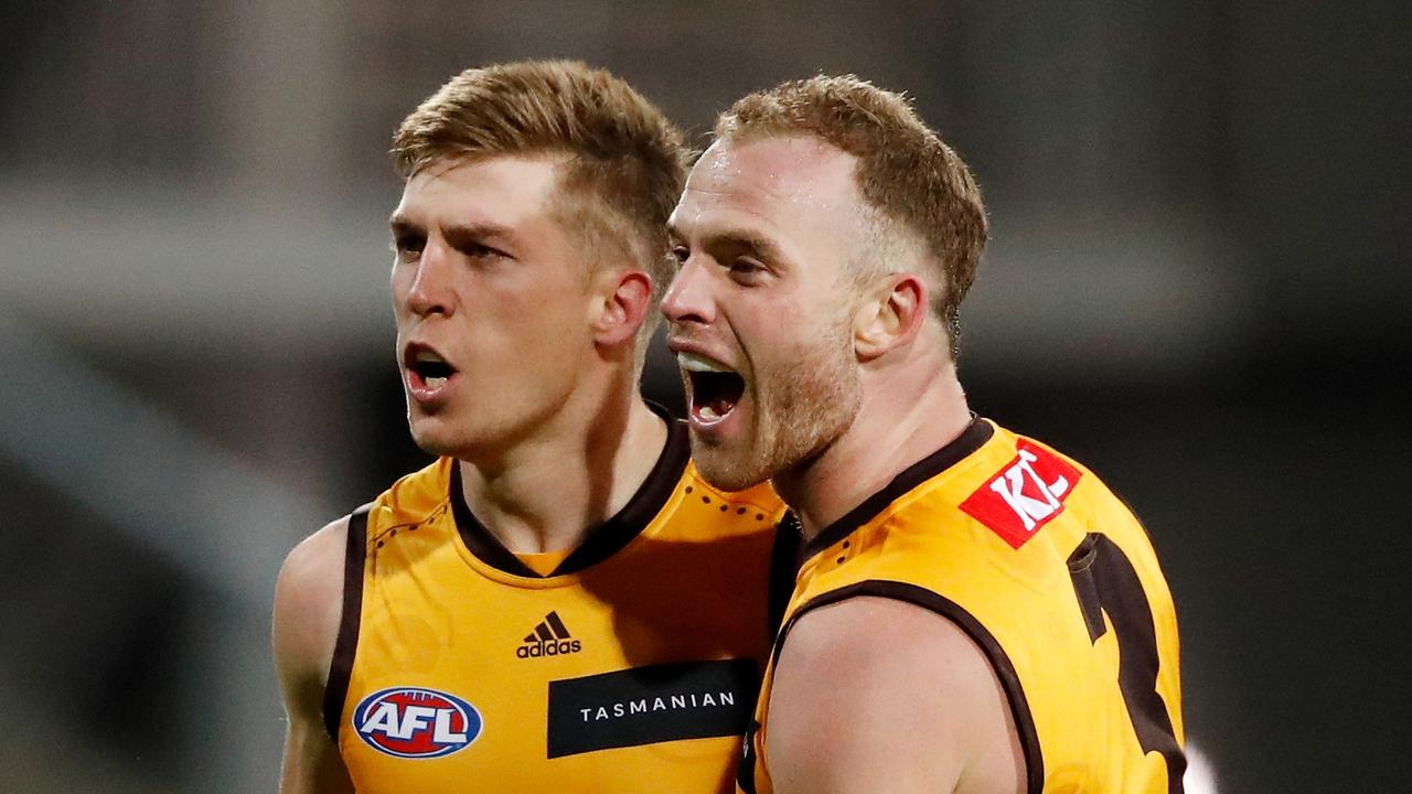 Dylan Moore of the Hawks celebrates a goal with Tom Mitchell. Photo by Dylan Burns/AFL Photos via Getty Images