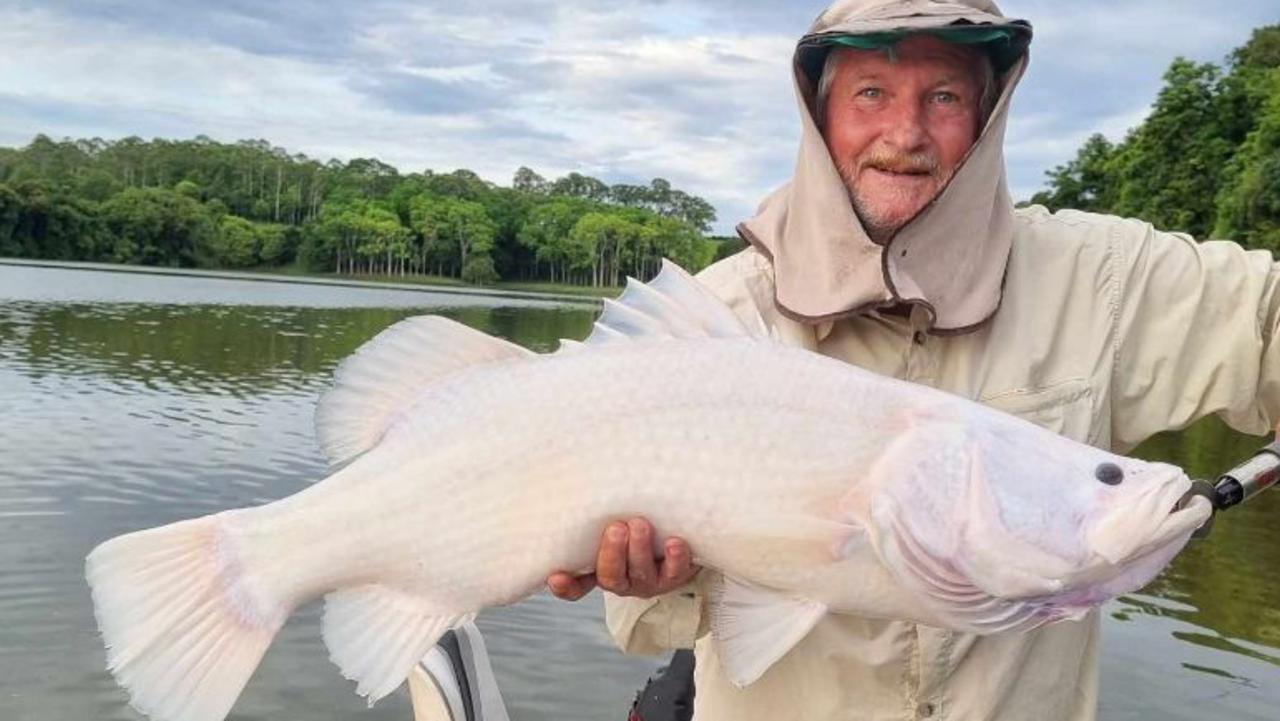 Tablelands Angler Alan Macdonald with a rare albino barramundi he caught while fishing Lake Tinaroo. Photo: Supplied