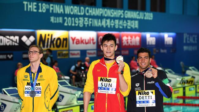 Mack Horton stands to the side of gold medallist China's Sun Yang (C) and bronze medallist Italy's Gabriele Detti after the 400m freestyle final. Picture: AFP