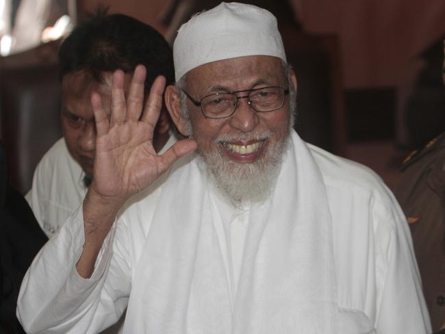 Radical cleric Abu Bakar Bashir waves to photographers during his trial at a district court in Jakarta, Indonesia, Monday, May 9, 2011. Prosecutors on Monday demanded life in prison for the fiery 72-year-old cleric, saying he helped plan and fund terrorist activities in the world's most populous Muslim nation. (AP Photo/Tatan Syuflana)