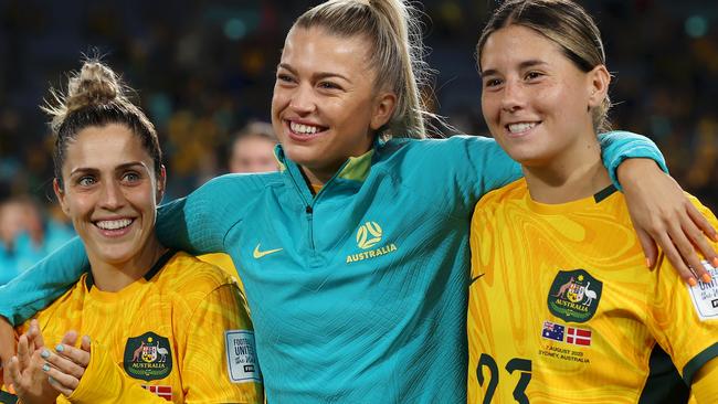 SYDNEY, AUSTRALIA - AUGUST 07: (L-R) Katrina Gorry, Charlotte Grant and Kyra Cooney-Cross of Australia celebrate the teamâs 2-0 victory and advance to the quarter final following the FIFA Women's World Cup Australia & New Zealand 2023 Round of 16 match between Australia and Denmark at Stadium Australia on August 07, 2023 in Sydney / Gadigal, Australia. (Photo by Maddie Meyer - FIFA/FIFA via Getty Images)