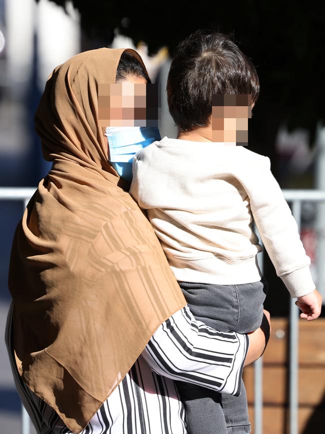 A woman and her son depart the Hotel Grand Chancellor in Adelaide after completing their 14-day quarantine. Picture: NCA NewsWire / David Mariuz