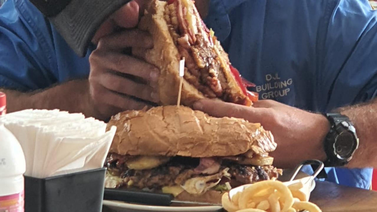 WESTERN DOWNS’ BIGGEST BURGER: A victim of the ‘Oversized Burger’ who took home a doggie-bag after failing to finish the 2kg burger. Pic: Sharpy's