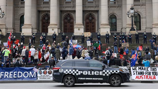 Police patrol the protest on the steps of parliament. Picture: Ian Currie