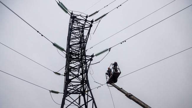 Workers repair high-voltage power lines cut by Russian missile strikes near Odesa. Picture: AFP