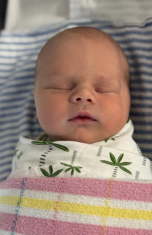 Tasmanian ironman champion Matt Bevilacqua and partner Brielle Cooper with their new baby Beau Peter born on the Gold Coast on May 28. Picture supplied by the family.