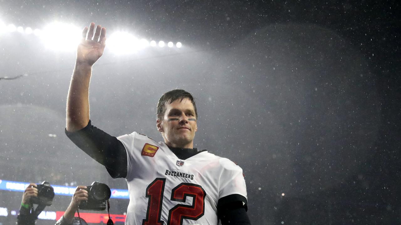 (FILES) In this file photo taken on October 03, 2021, Tom Brady, #12 of the Tampa Bay Buccaneers, waves to the crowd as he runs off the field after defeating the New England Patriots in the game at Gillette Stadium in Foxborough, Massachusetts. - Seven-time Super Bowl champion quarterback Tom Brady will retire after 22 NFL seasons, according to multiple US media reports Saturday. (Photo by Maddie Meyer / GETTY IMAGES NORTH AMERICA / AFP)