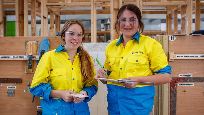 High school students Lily Harbottle and Kiarna Falzon at a girls-only TAFE SA program to give school students a hands-on taste of working in the building trades industry. Picture: Matt Turner.