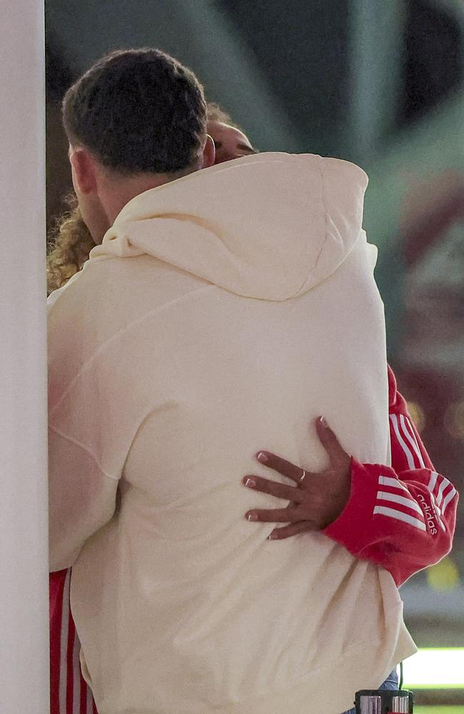 The loved-up pair were seen cuddling at Sydney airport on Monday morning. Picture: Media Mode