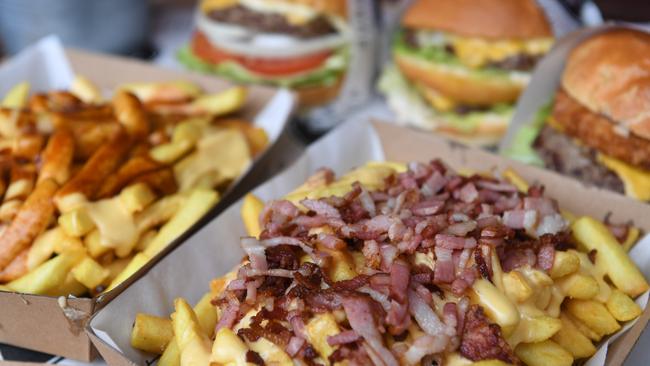 Poutine chips (left) and loaded chips are seen in front of the Proppa Whoppa, McDowell and Son of a Bun burgers. Picture: Julian Smith