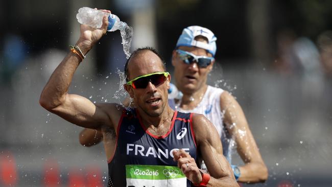 Yohann Diniz, of France, splashes water onto his head during the men's 50-km race walk.