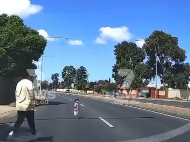 Two men quickly raced from their cars to grab the young girl. Picture: 7NEWS.