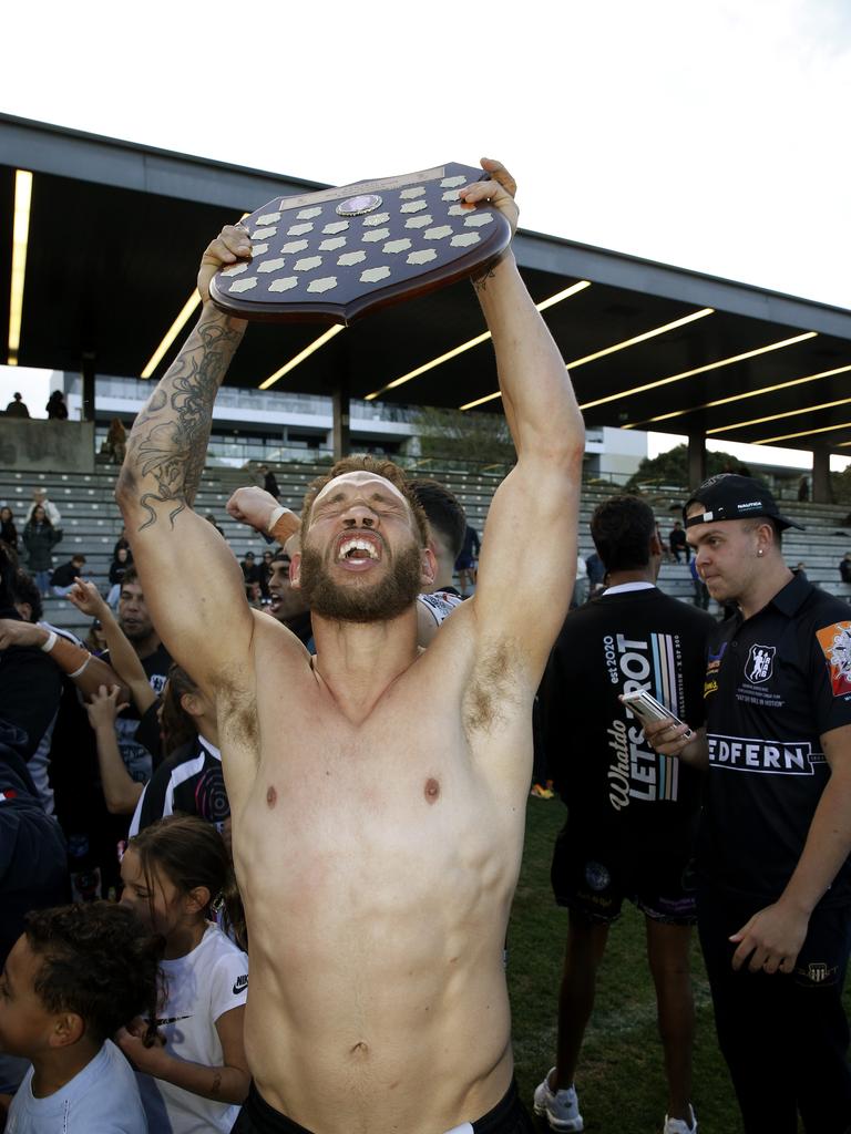 Eli Roberts raises the shield to celebrate Redfern All Blacks victory. Picture: John Appleyard