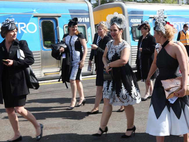 Racegoers arrive at Flemington racecourse. Picture: David Crosling