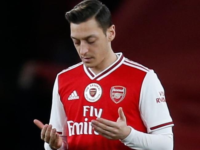 Arsenal's German midfielder Mesut Ozil gestures before kick off in the English Premier League football match between Arsenal and Manchester City at the Emirates Stadium in London on December 15, 2019. (Photo by Ian KINGTON / IKIMAGES / AFP) / RESTRICTED TO EDITORIAL USE. No use with unauthorized audio, video, data, fixture lists, club/league logos or 'live' services. Online in-match use limited to 45 images, no video emulation. No use in betting, games or single club/league/player publications.