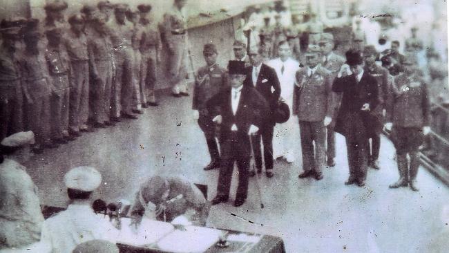 General MacArthur signing the Japanese surrender to World War II aboard the USS Missouri on 6 August 1945, with Japanese Emperor Hirohito with top hat waiting to add his endorsement. It is supplied courtesy Cranbourne RSL. Picture: Derrick den Hollander