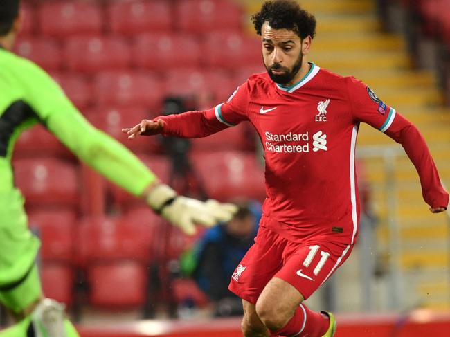 Liverpool's Egyptian midfielder Mohamed Salah (R) takes a shot during the UEFA Champions League quarter final second leg football match between Liverpool and Real Madrid at Anfield in Liverpool, north west England on April 14, 2021. (Photo by Paul ELLIS / AFP)