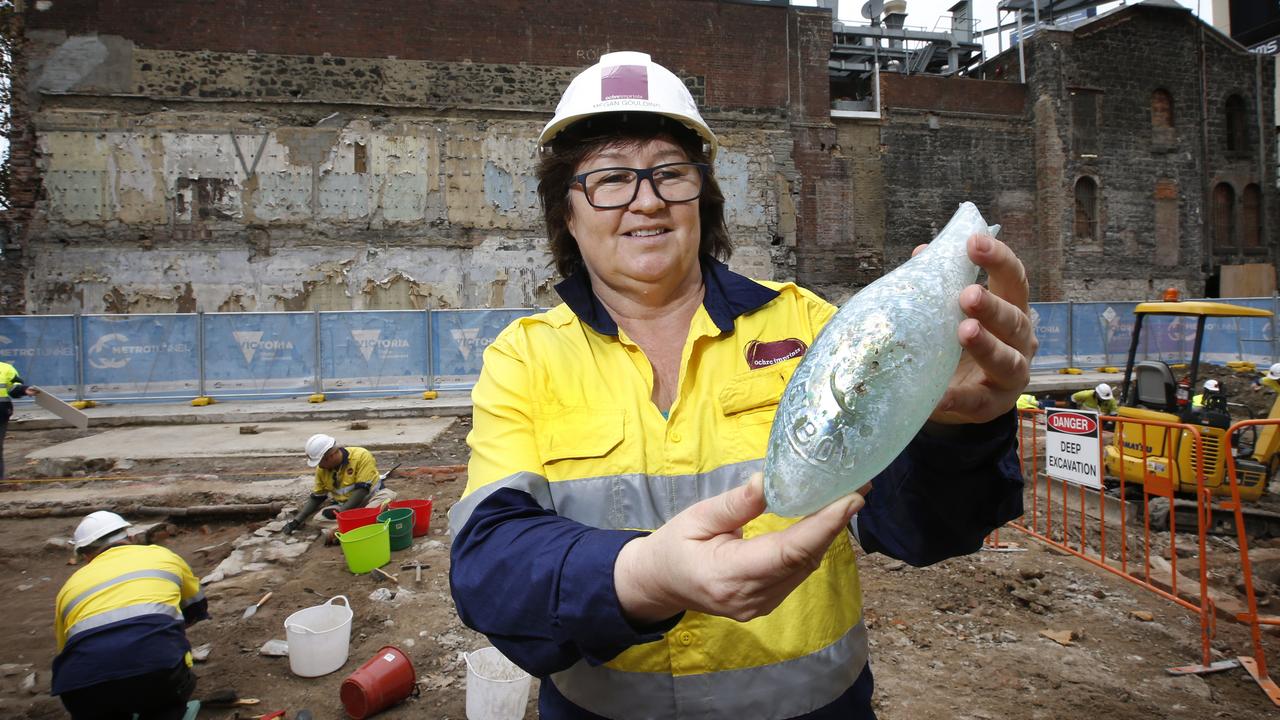 An architectural dig discovered artefacts, including a 1900s-manufactured torpedo bottle held by excavation director Meg Goulding, behind Young and Jackson in 2018. The Victorian government is now building part of the future Metro tunnel on the site. Picture: David Caird.