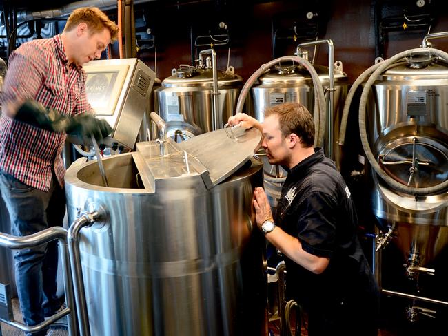 Bryn mashes the malt while Andrew inspects. Photo Jeremy Piper