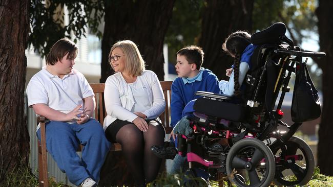 Jacqueline Lockyer chats to students (from left) Liam McIntyre, 17, Liam Platten, 12, and Jaya Russell, 17. Pictures: Robert Pozo