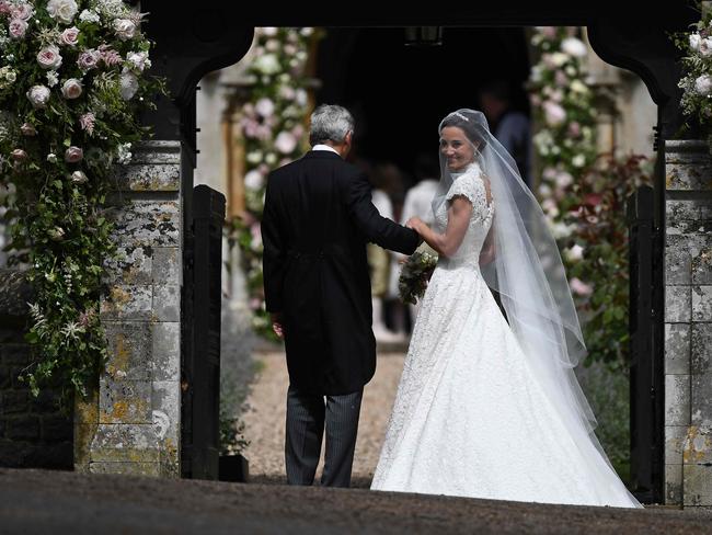 Pippa Middleton is escorted by her father Michael Middleton, as she arrives for her wedding to James Matthews.