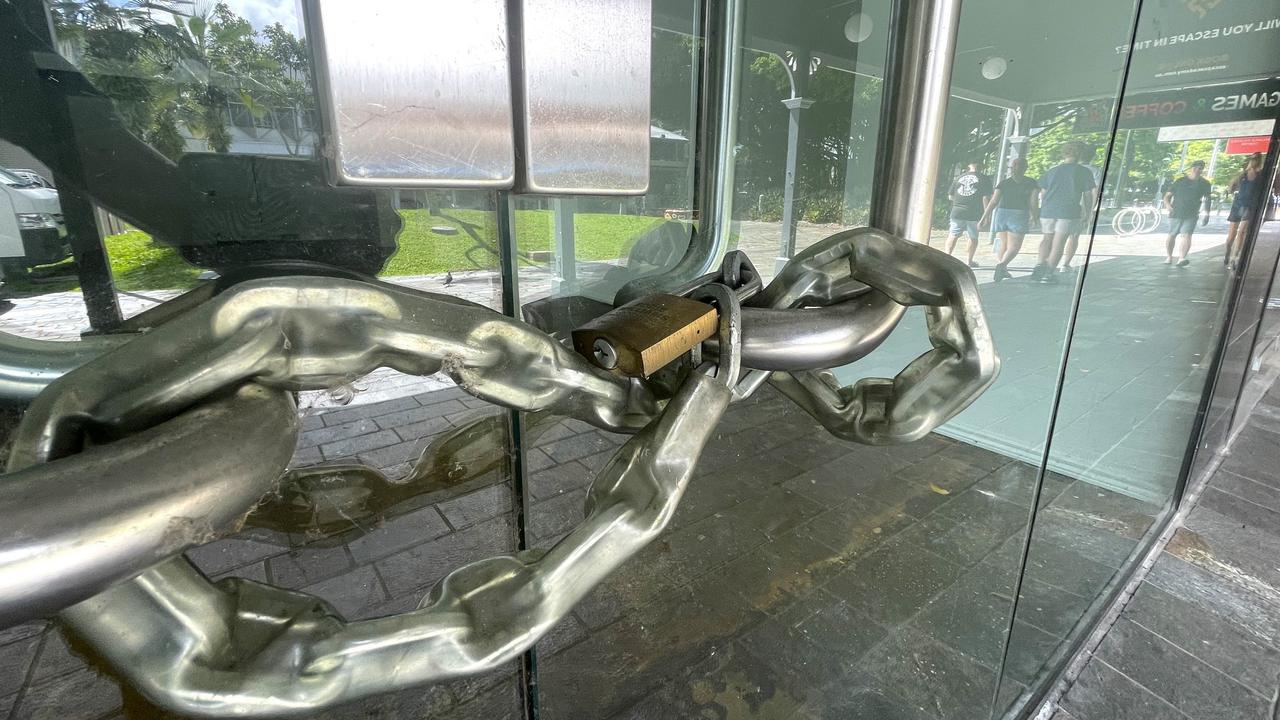 Thick chains lock the doors of an empty Shields St shop. Picture: Peter Carruthers
