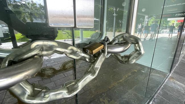 Thick chains lock the doors of an empty Shields St shop. Picture: Peter Carruthers
