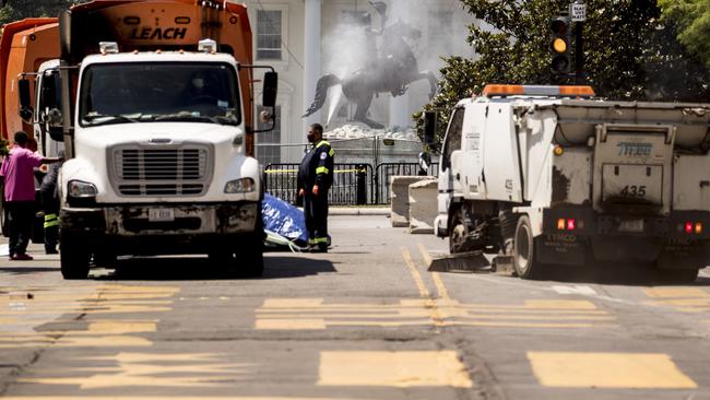 A statue of Andrew Jackson in Lafayette Park is pressure washed after being attacked by protesters. Picture: AP.