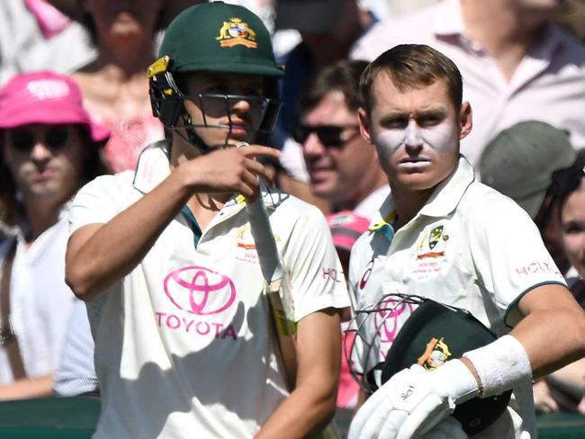 Australia's Sam Konstas (L) and Marnus Labuschagne wait to walk onto the field on day two of the fifth Test between Australia and India at the Sydney Cricket Ground on January 4, 2025. (Photo by Saeed KHAN / AFP)