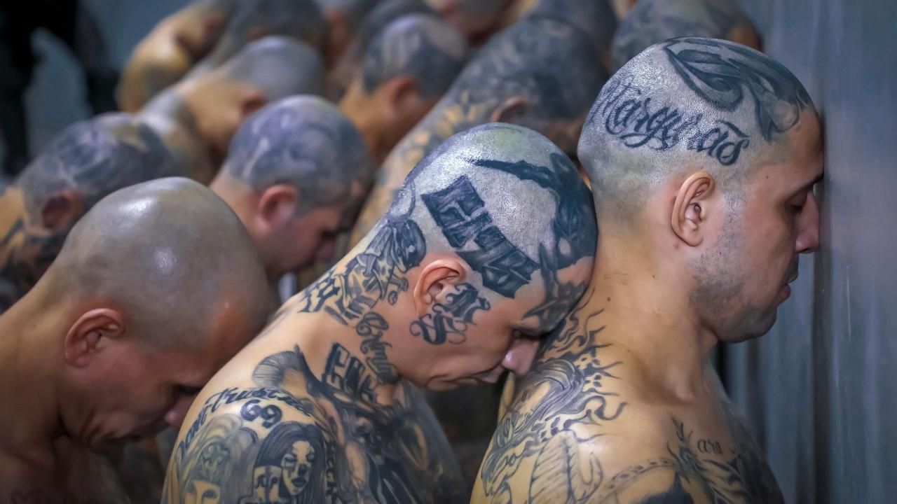 The gang members were transferred from the Izalco prison to "America's largest" mega-prison, equipped with hi-tech surveillance and designed to house 40,000 criminals. (Photo by Salvadorean Presidency / AFP)