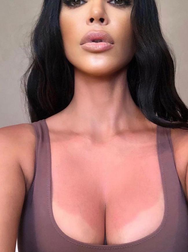 Kim Kardashian before using KKW Beauty body makeup to cover sunburn and pigment on her chest.