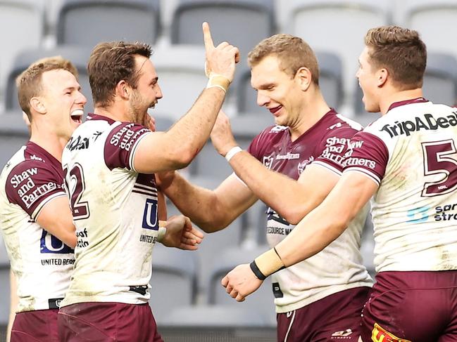 SYDNEY, AUSTRALIA - JULY 03: Reuben Garrick of the Sea Eagles celebrates with his team mates scoring a try during the round 16 NRL match between the Canterbury Bulldogs and the Manly Sea Eagles at Stadium Australia, on July 03, 2021, in Sydney, Australia. (Photo by Mark Kolbe/Getty Images)