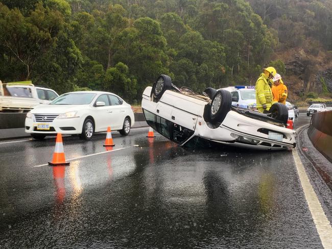 A car rolled in a single-vehicle crash on the Southern Outlet. Picture: MATHEW FARRELL