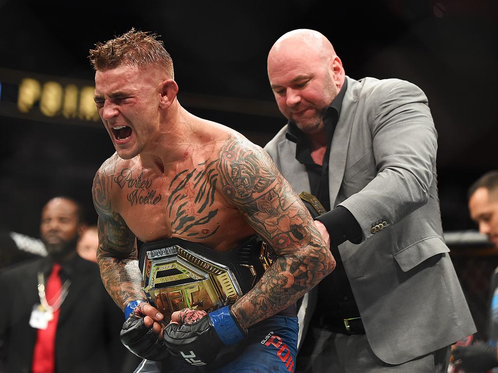 Dustin Poirier celebrates after receiving the interim belt from UFC President Dana White. (Photo by Logan Riely/Getty Images)