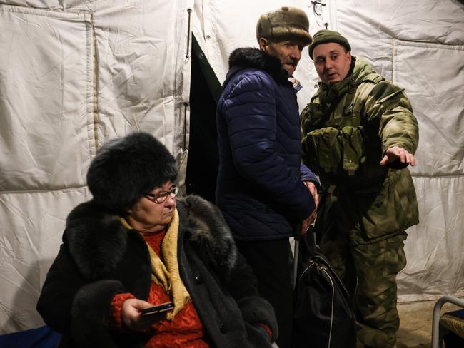 Evacuated Mariupol civilians and a serviceman at a relief centre for evacuees of the DPR Emergency Service in the village of Bezymennoye.