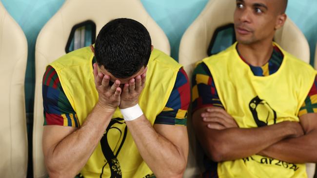 Cristiano Ronaldo sits on the bench during the Switzerland game at Lusail Stadium.