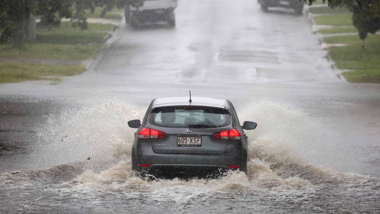 A flooded road in Carina on Sunday. Most residents are staying home but some bus services have resumed and some are taking short trips in their cars. Picture: NewsWire/Tertius Pickard