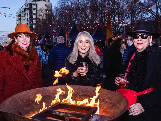 Susan Gannon, Sharyn Midgley and Chris Samim enjoying a fireside wine at Winter Feast. Picture: Linda Higginson