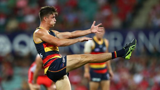 Riley Knight boots one of his two majors against the Swans.