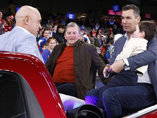 North Melbourne premiership players Wayne Schwass and Wayne Carey with coach Denis Pagan at a motorcade at Marvel Stadium. Picture: Darrian Traynor